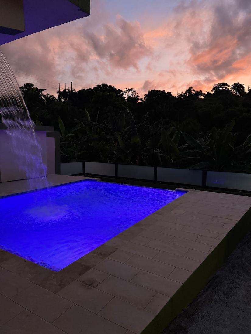 Villa Verde pool with waterfall at sunset
